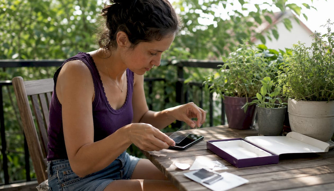 Person applying tempered glass protector on phone