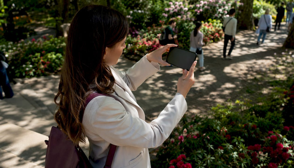 Commuter using phone with anti-glare protector outdoors