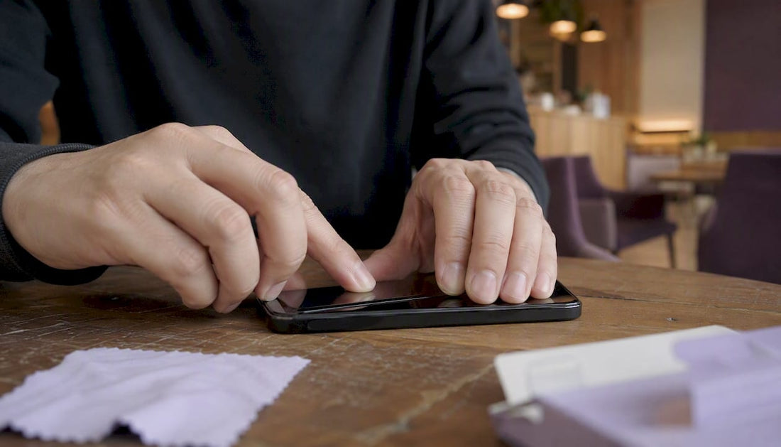 Hands pressing screen protector edge on phone