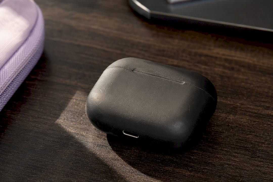Close-up of AirPods charging case with visible wear