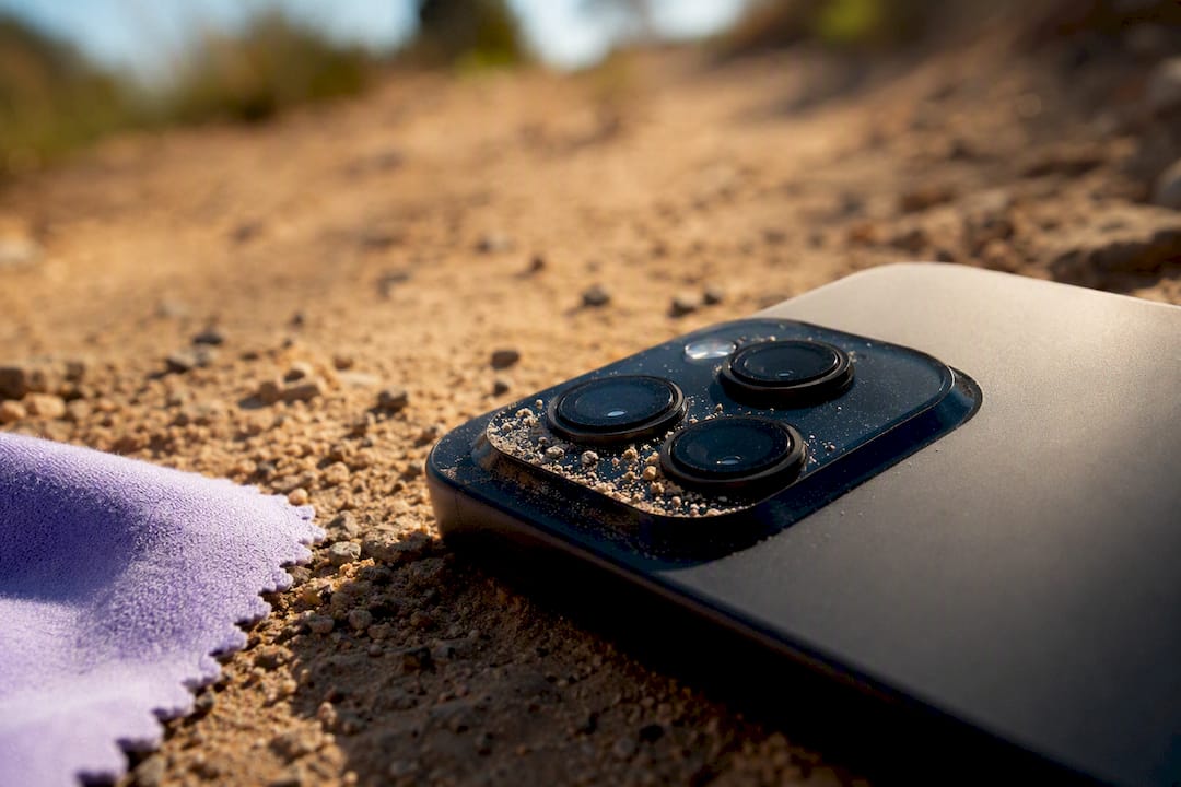 Cropped phone camera near gritty sand
