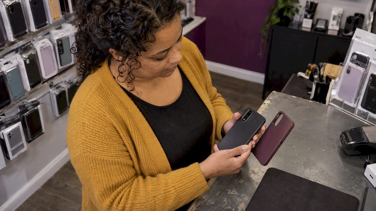 Shop assistant checking an older phone case fit